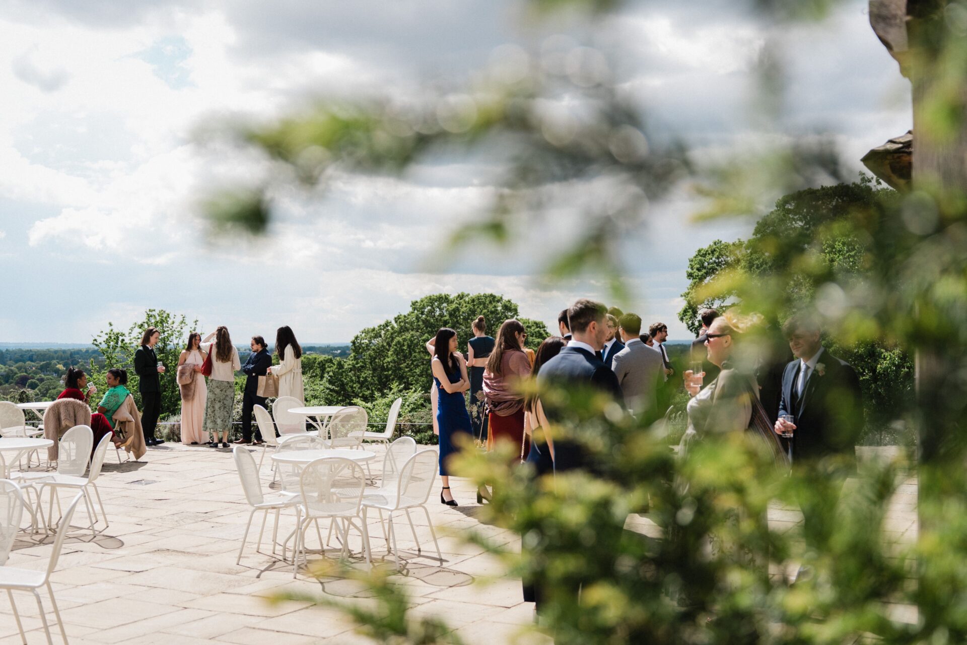 Wedding guests gathered on a large patio.