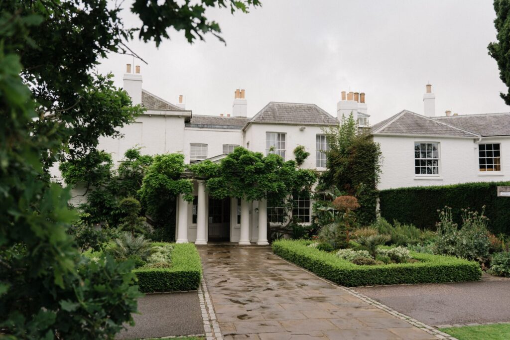 A view of Pembroke Lodge and its gardens on a cloudy day.