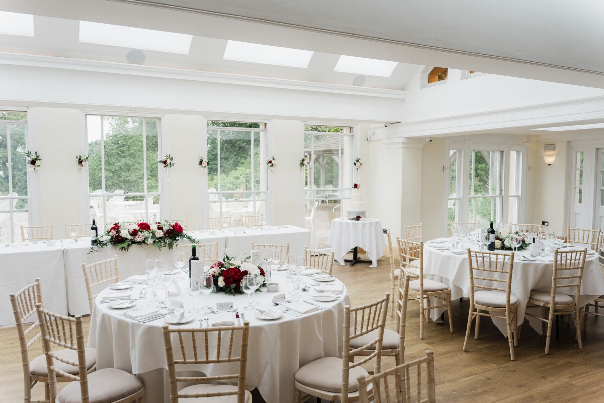 A large white room with set round tables.